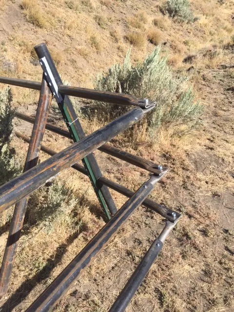 Steel jack fence following uneven Idaho terrain